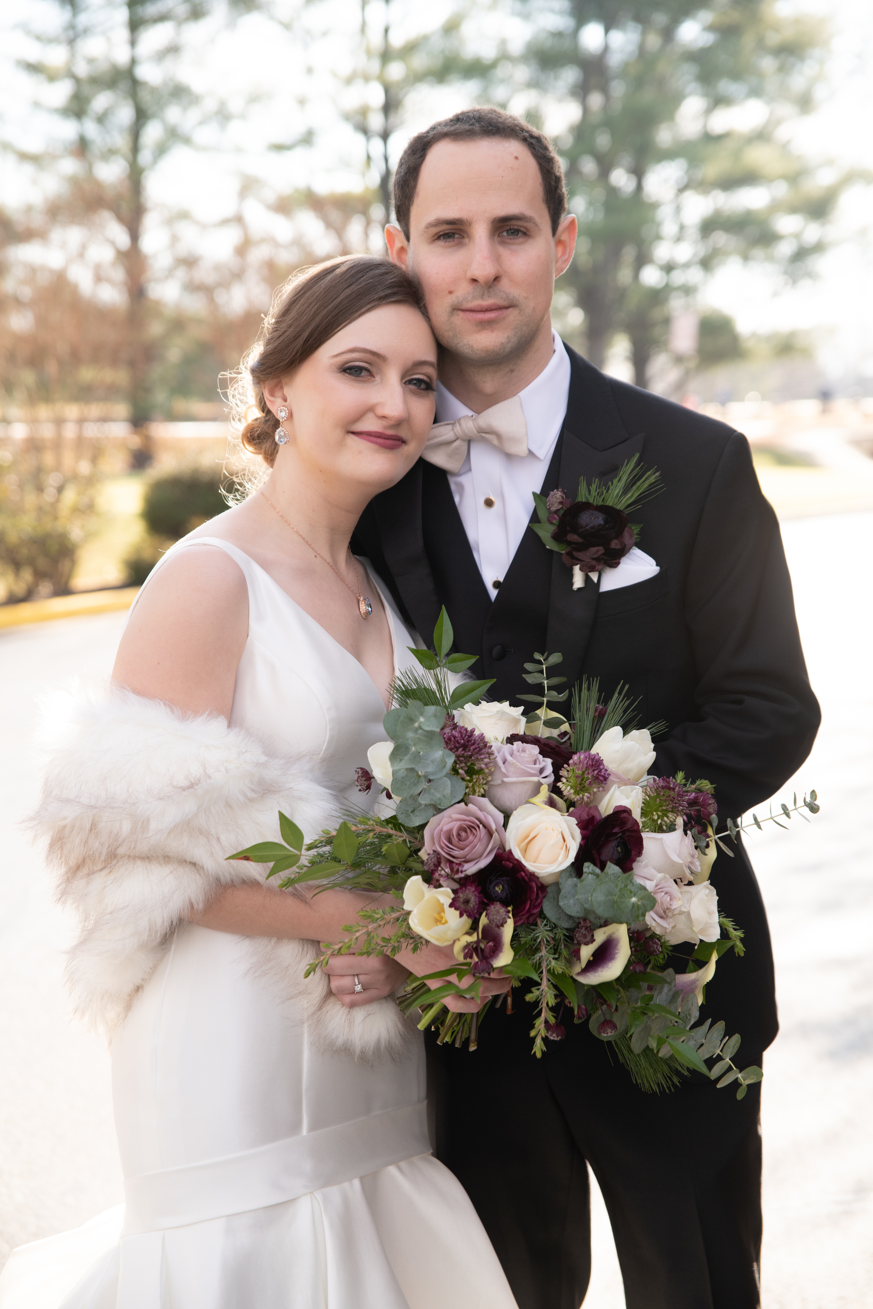 bride and groom with boutonniere and bridal bouquet